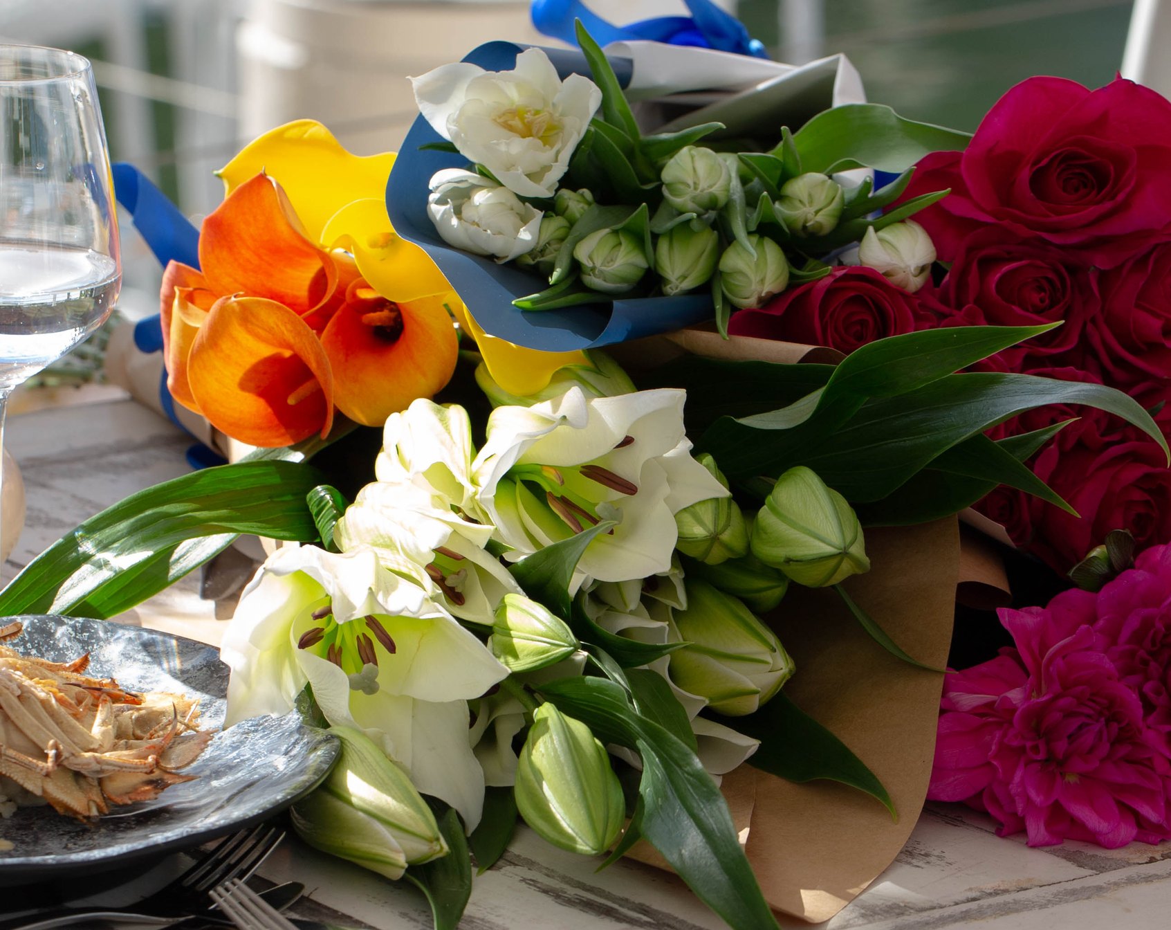 Fresh bouquets laid across a riverside table