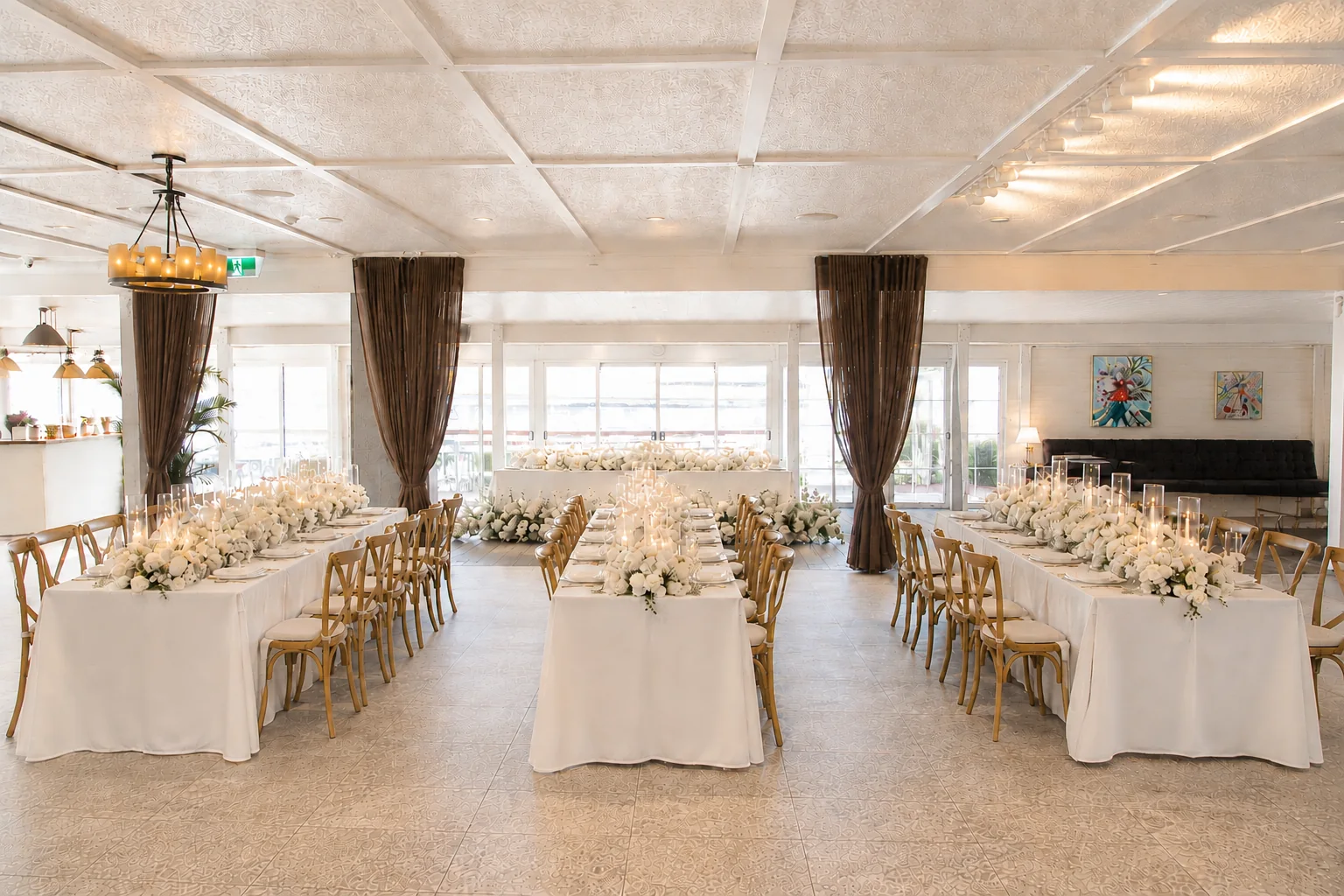 River House reception room dressed with long tables, white flowers and candlelight